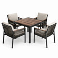 Conjunto de comedor de metal y madera con sillas de cuerda y cojines beige